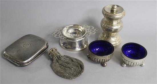 A late Victorian silver pepper mill, London, 1898, a silver travelling timepiece, a purse, two salts and a tea strainer.